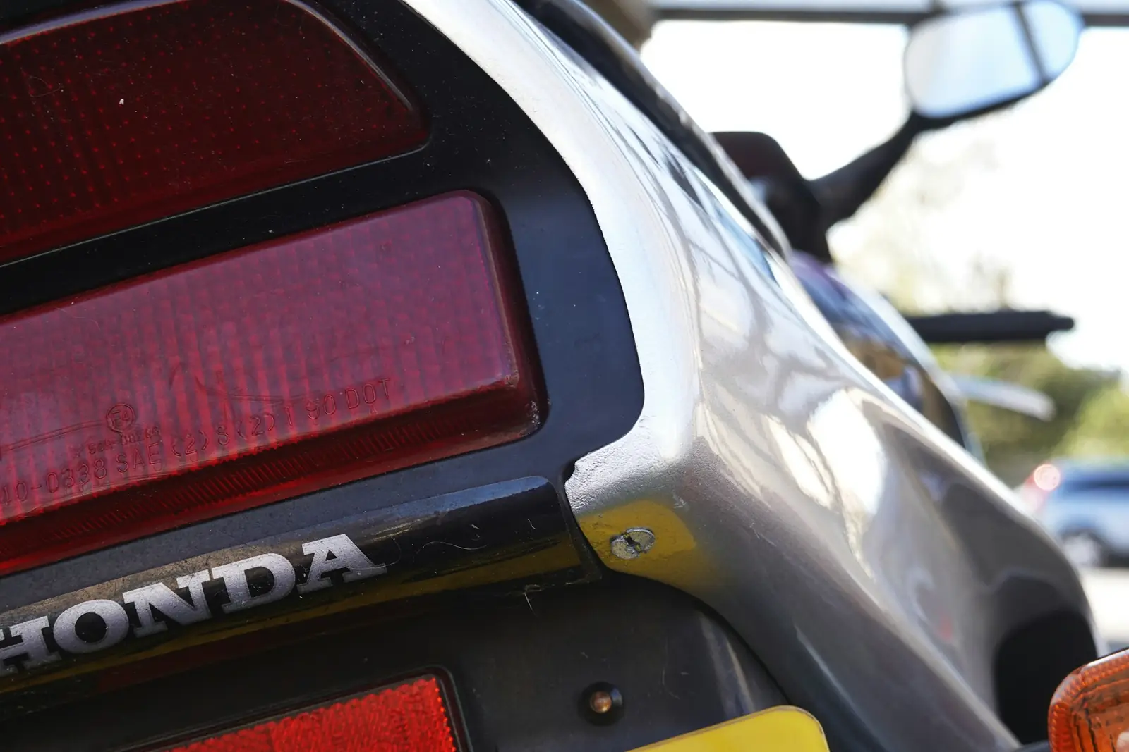Crumpled rear quarter panel and broken tail light on a damaged car